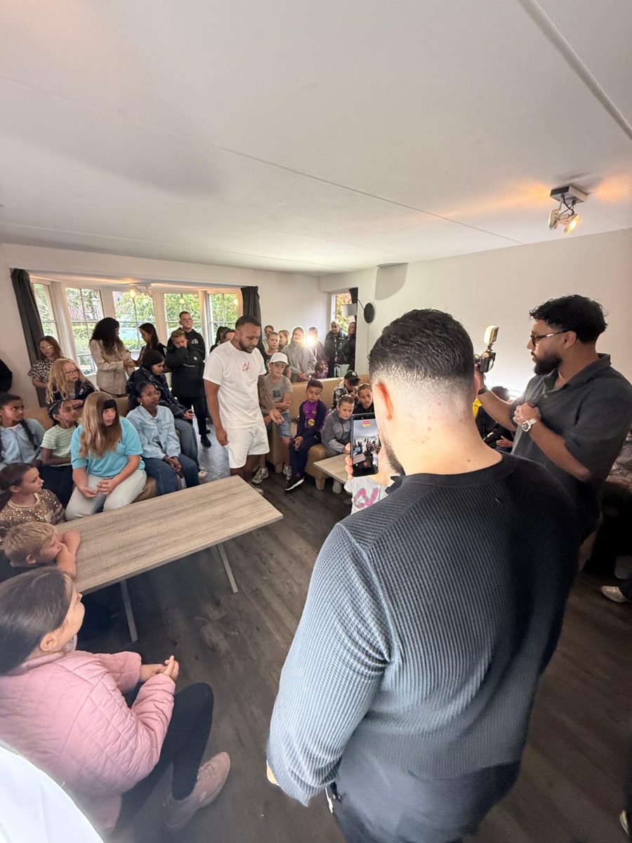 Nabil filmt Chachi Versaci in een zaal vol kinderen